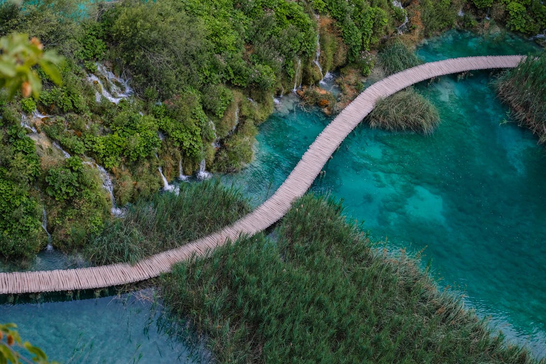 Free Long Wooden Bridge Over Blue Water of Plitvice Lakes in a National Park in Croatia  Stock Photo
