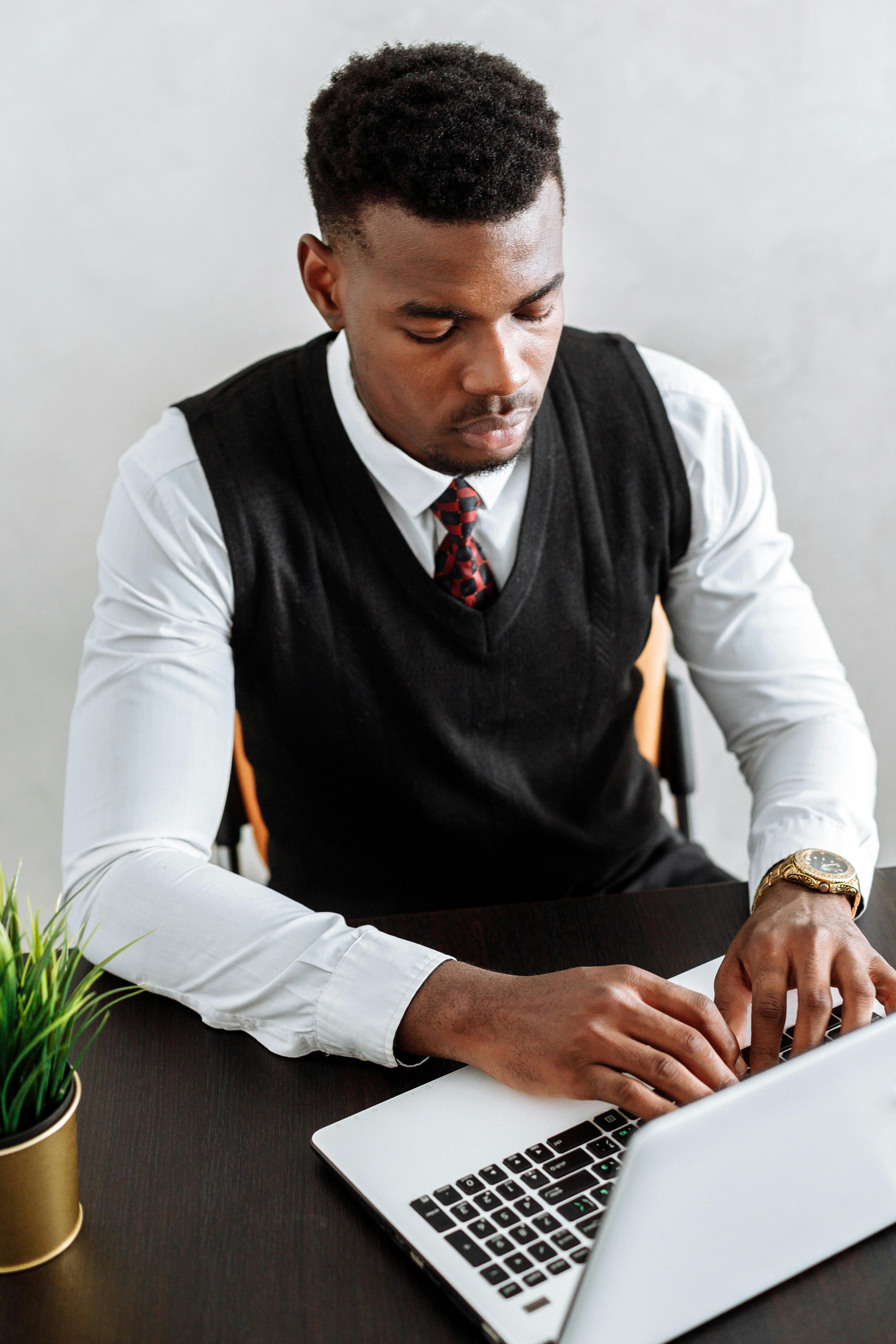 Focused businessman working on laptop in modern office