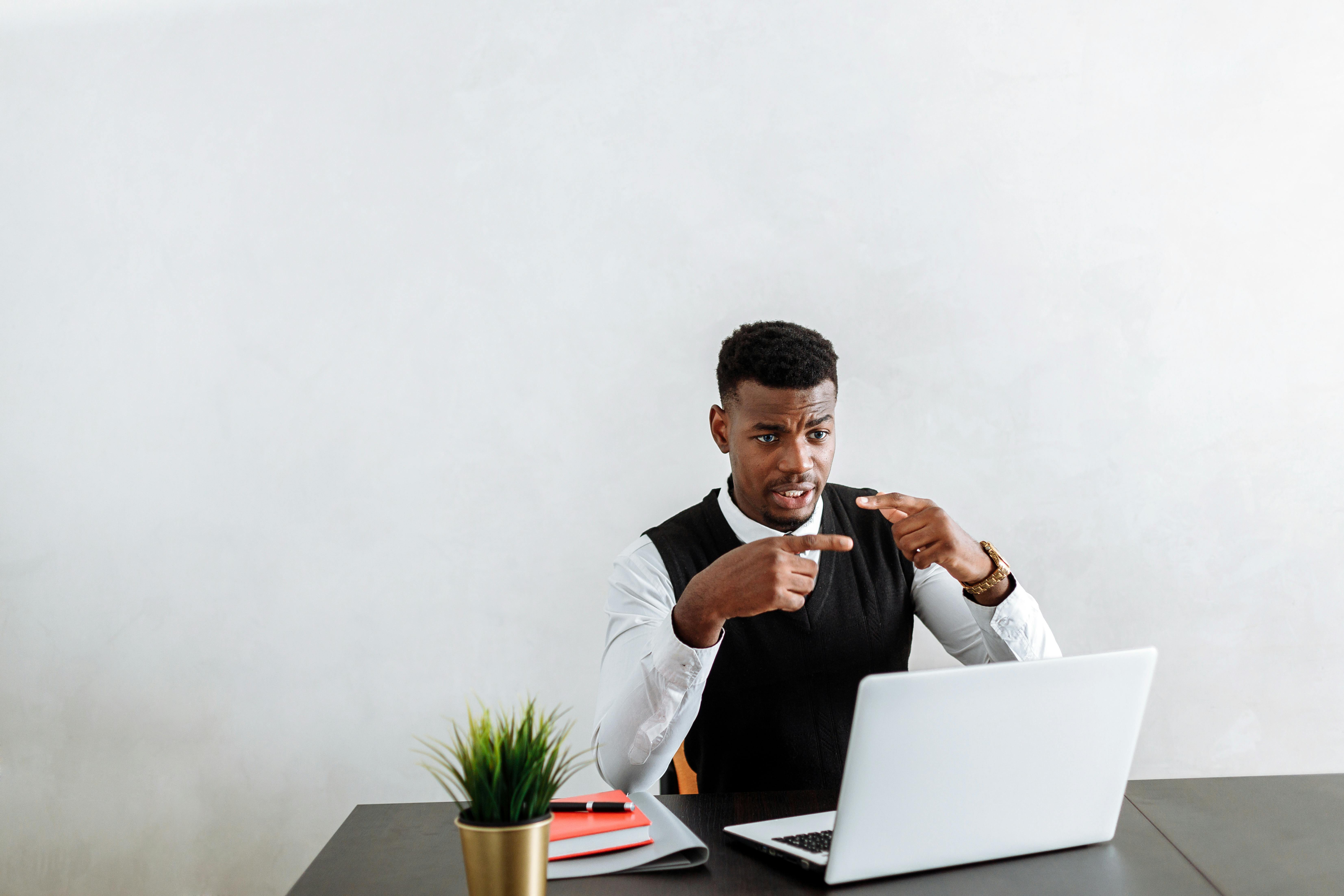 man in white dress shirt sitting at the table