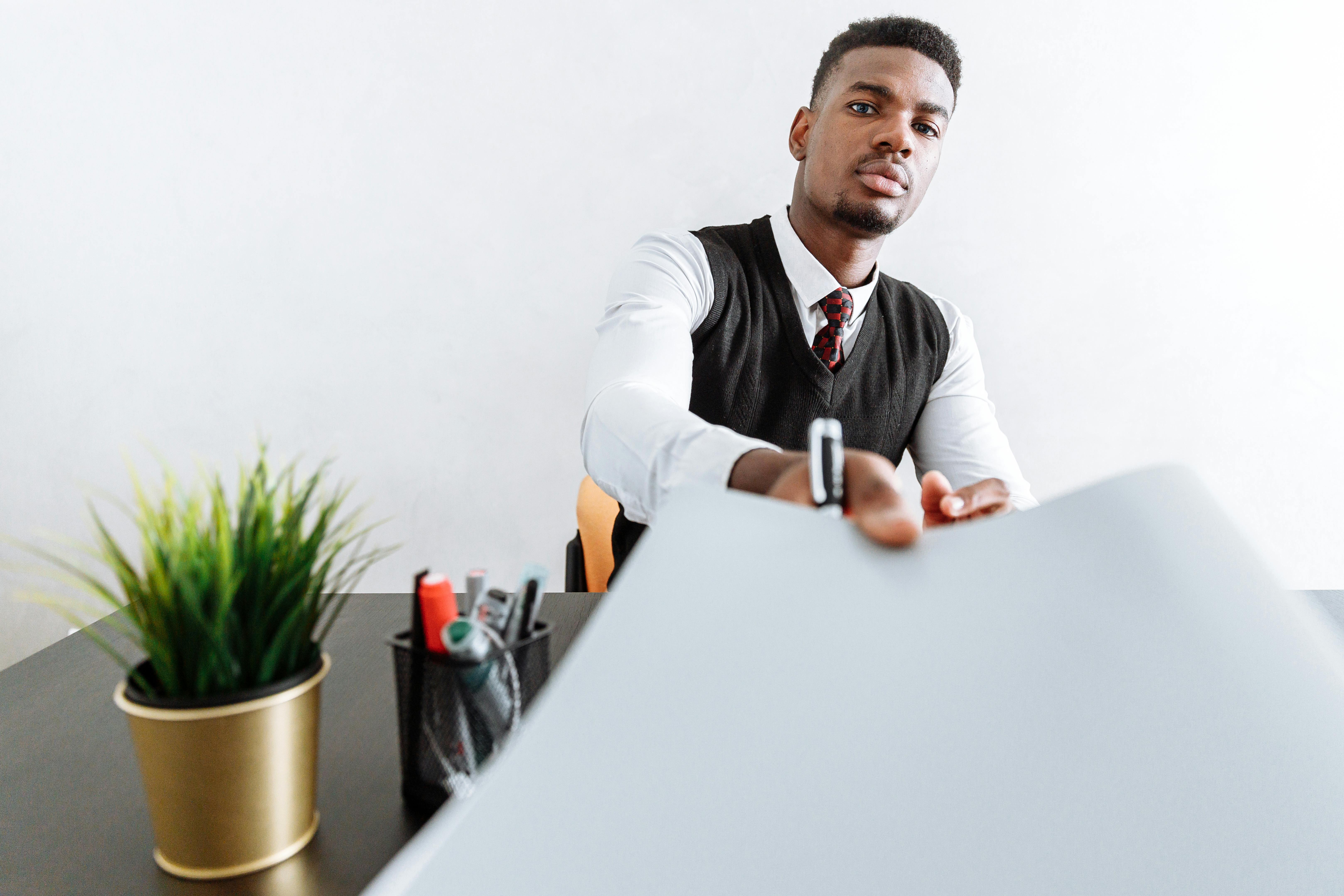 man in white dress shirt sitting at the table