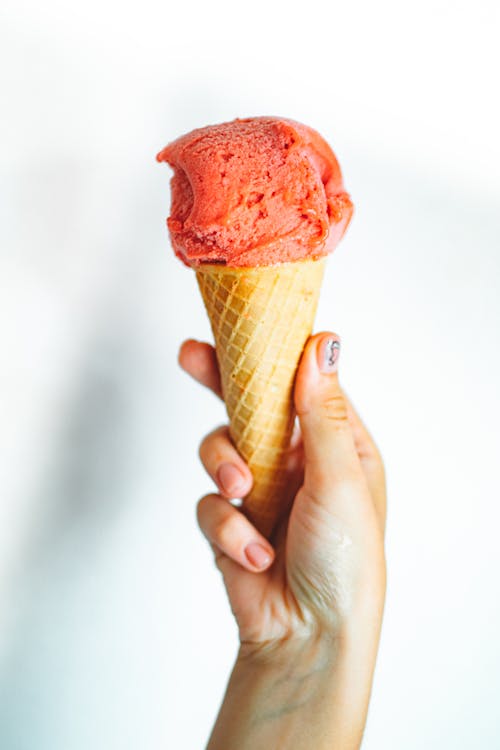 Free Person Holding an Ice Cream in a  Cone Stock Photo