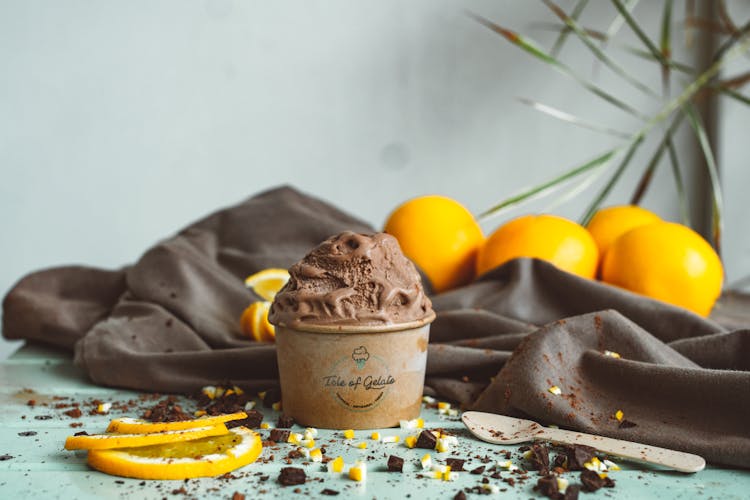 A Cup Of Chocolate Ice Cream With Lemon Bits