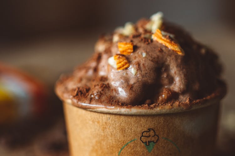 Melting Chocolate Ice Cream In Paper Cup