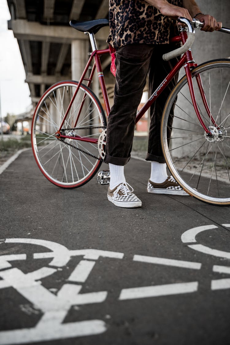 A Person Riding A Red Bicycle