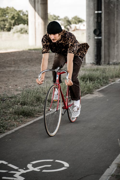 Man Riding a Bike on a Street 