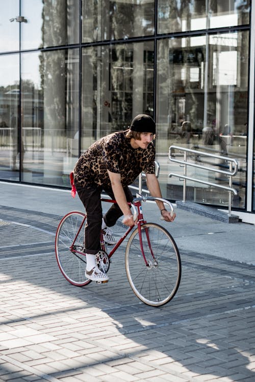 Photo of Man riding a Red Bicycle