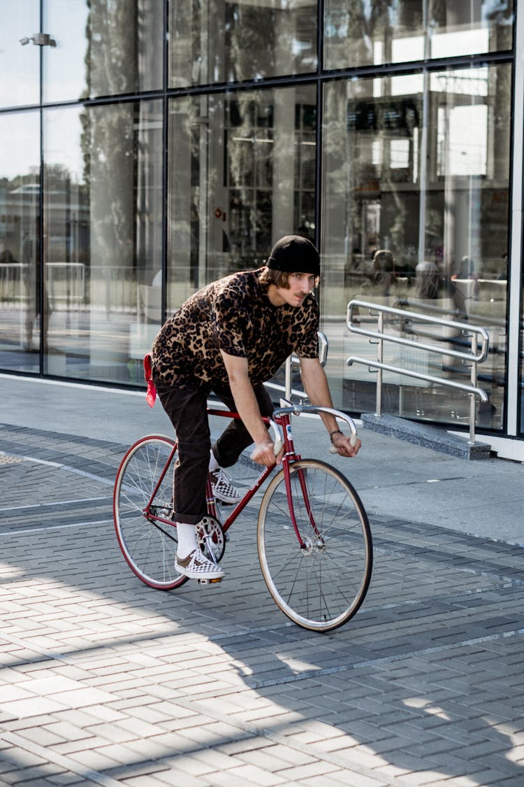 Photo Of Man Riding A Red Bicycle