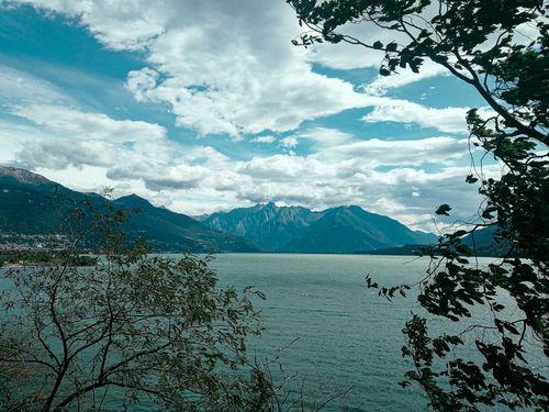 Free Amazing view of tranquil rippling bay near rough majestic mountains and lush trees on shoreline on sunny summer day Stock Photo