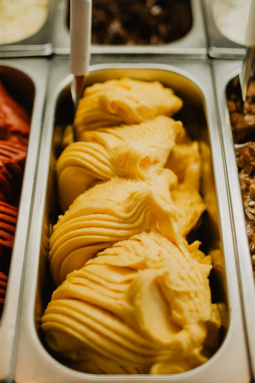Free Zoomed view of creamy mango gelato scoops ready to be served. Stock Photo