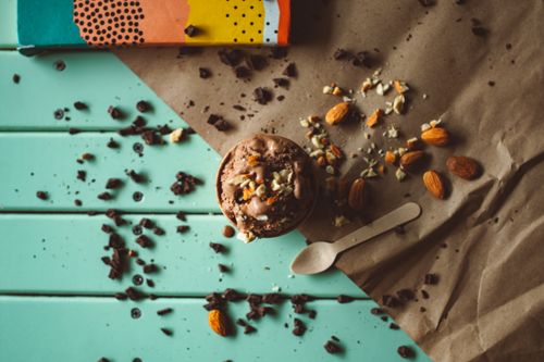 Free Top view of chocolate ice cream with almonds and chocolate bits on a colorful background. Stock Photo