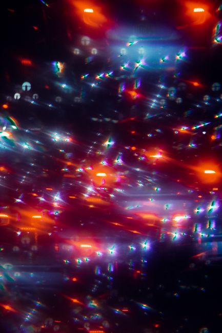 Abstract backdrop with colorful blurred glowing red and blue lights at dusk