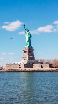Iconic view of the Statue of Liberty, a symbol of freedom, against a clear blue sky.