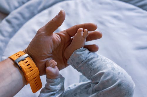 Person Holding Baby's Feet 