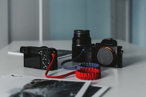 Black DSLR Cameras on White Table