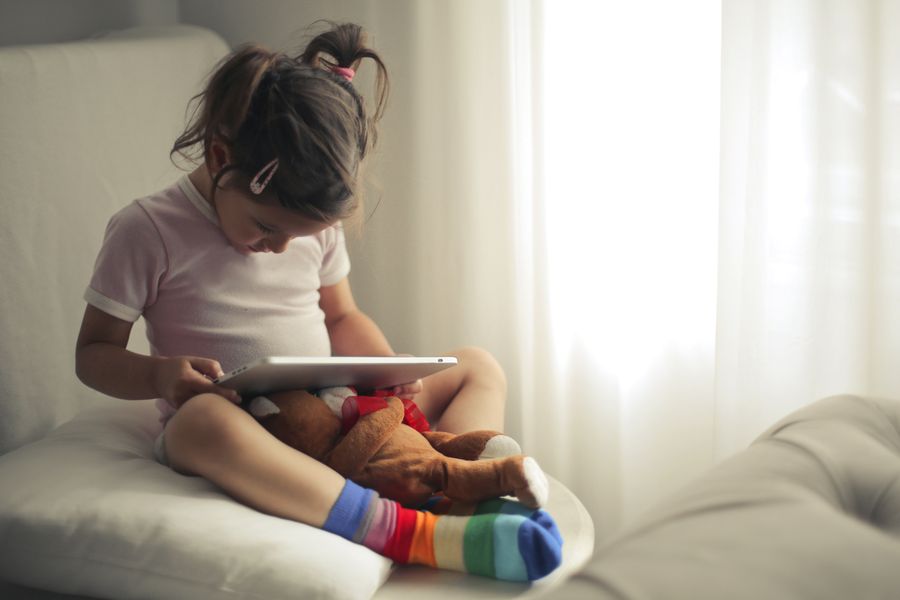 A young child using a tablet at home