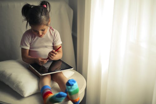 Free Girl Using a Tablet Computer Stock Photo