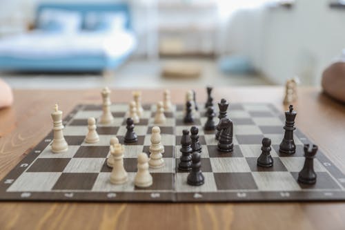 Chess board with figures in white background, Stock image