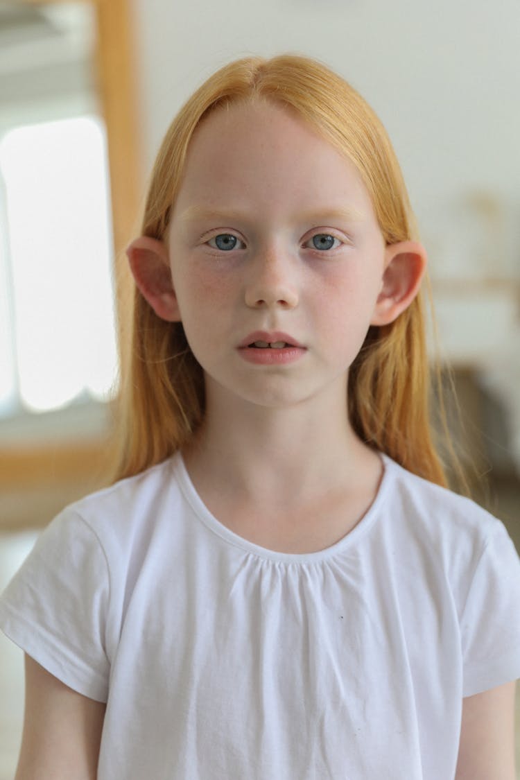 Pensive Redhead Girl In Room In Daylight