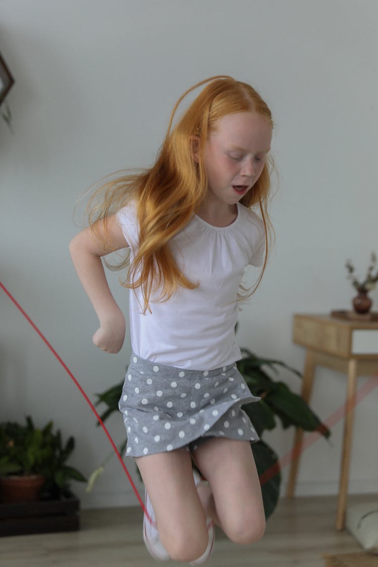 Cute Little Girl Jumping Rope At Home