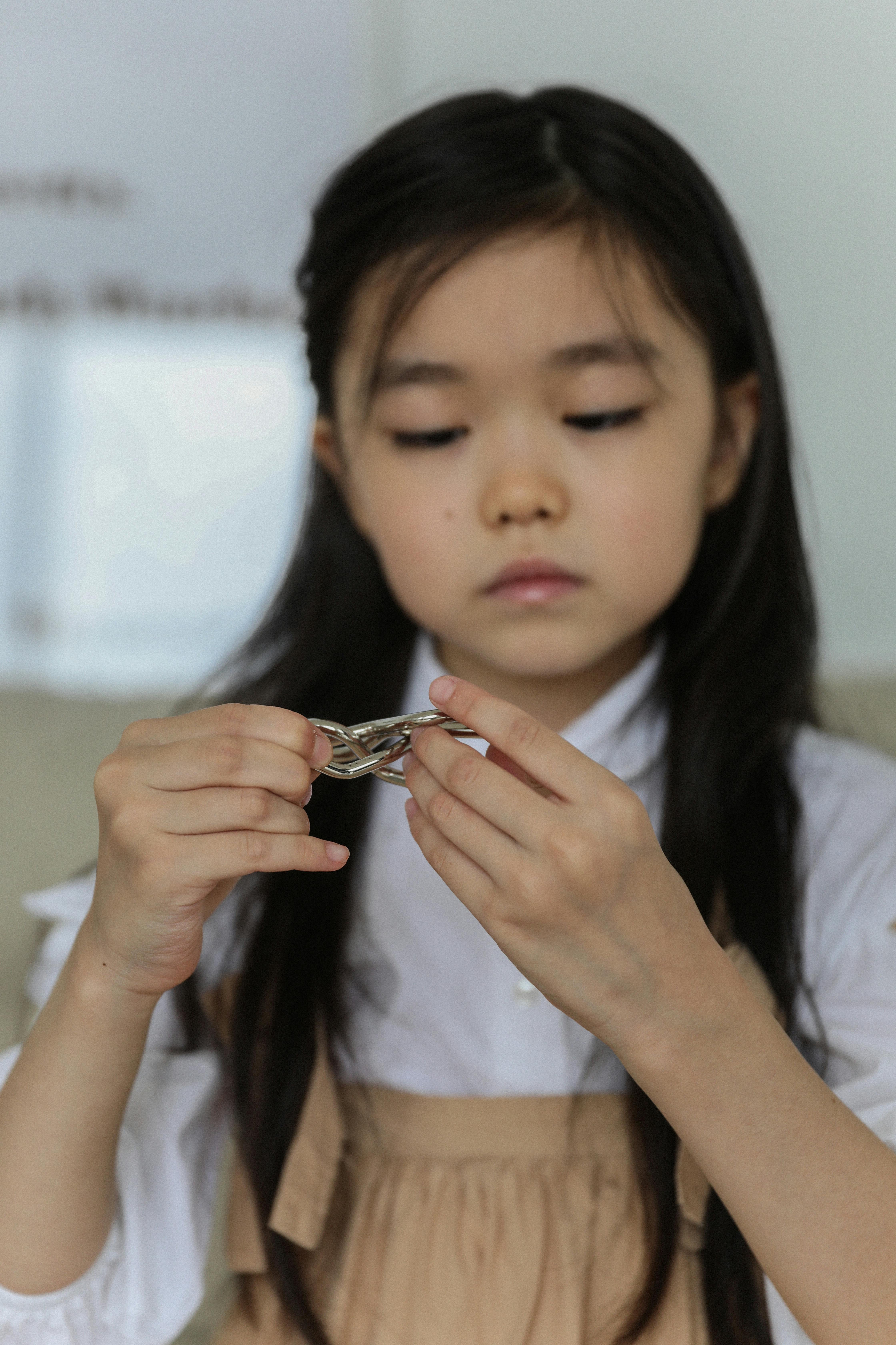 little asian girl playing game at home