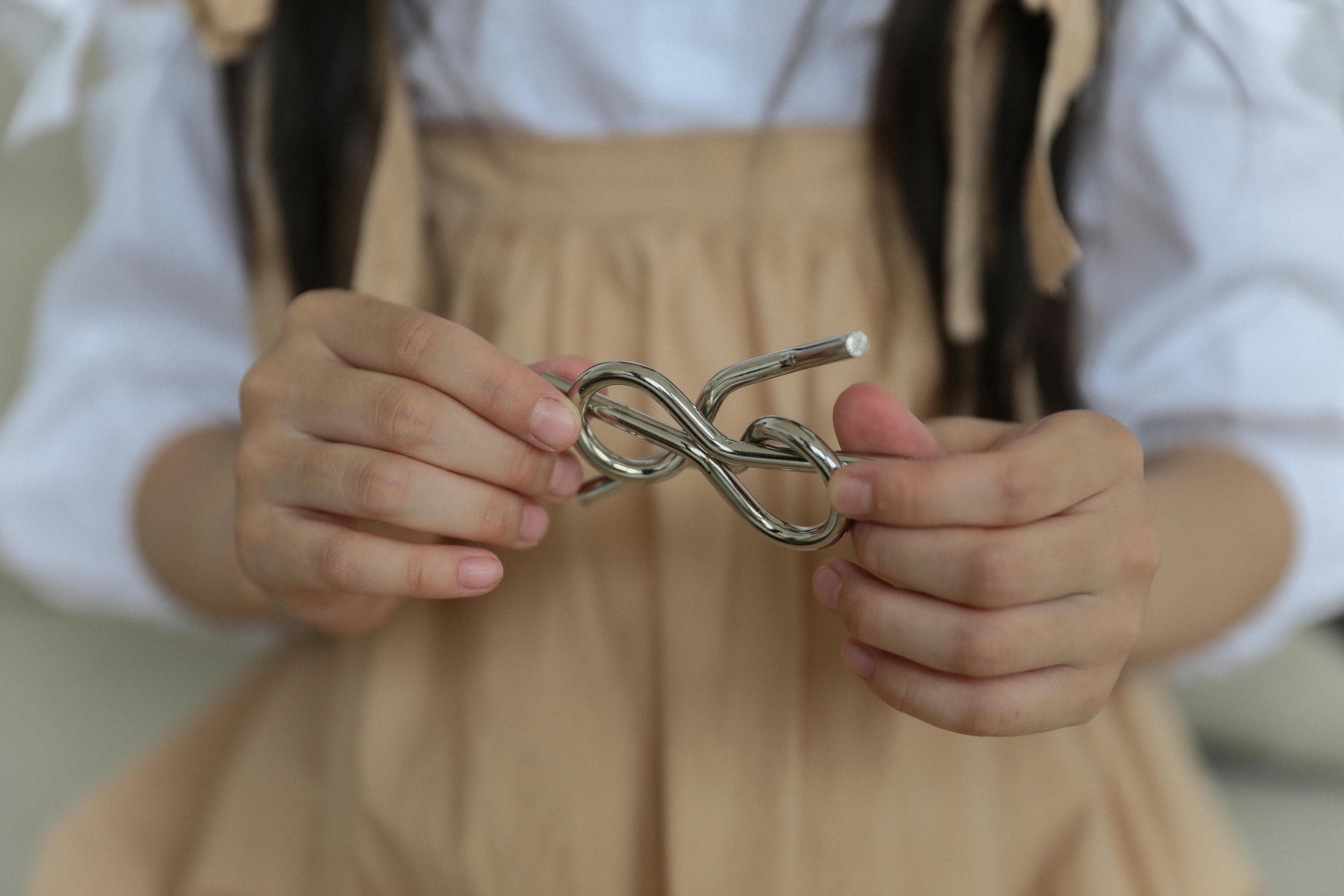 crop little girl holding metal knot teaser