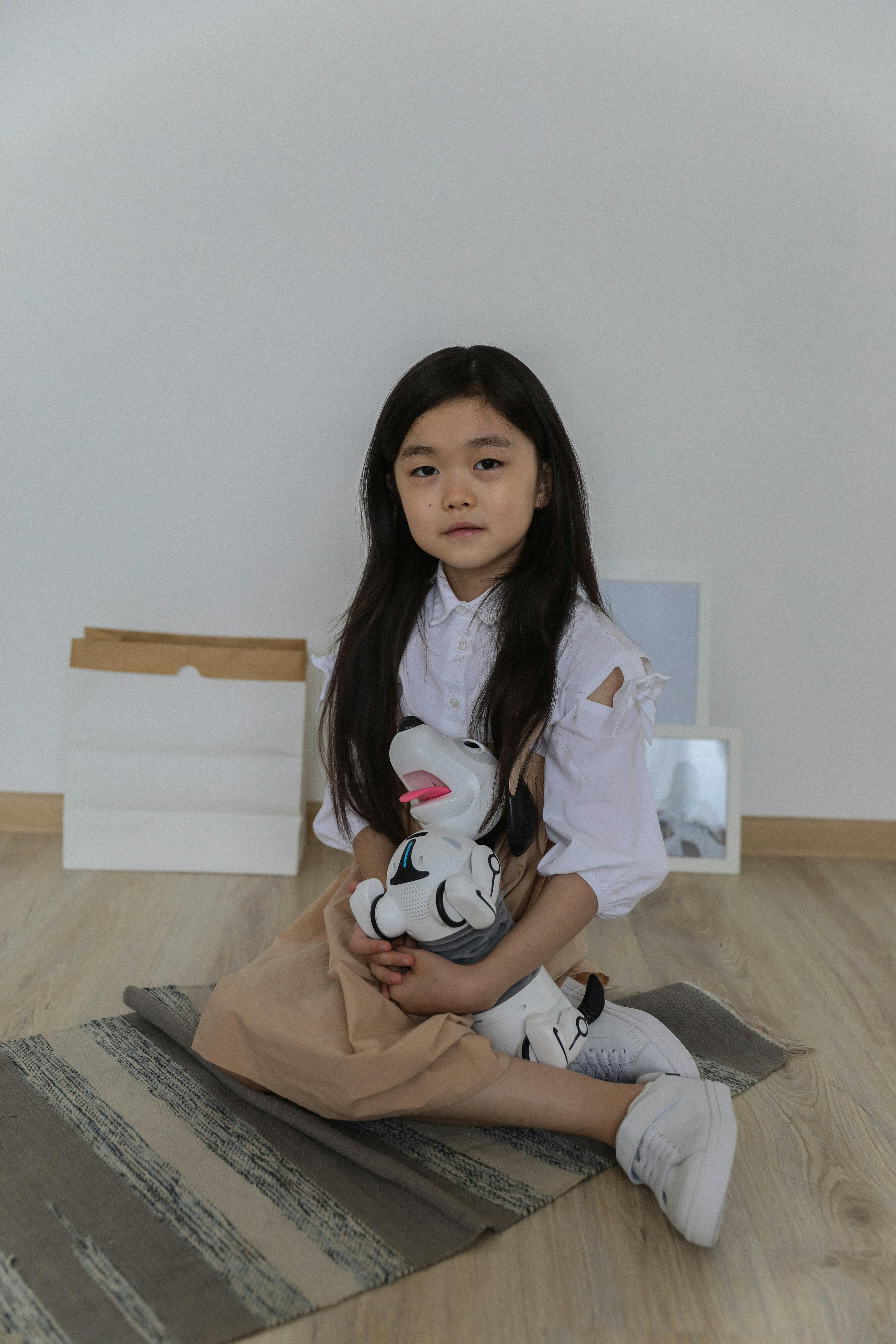 happy asian little girl sitting on floor