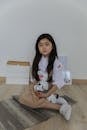 Happy Asian little girl sitting on floor
