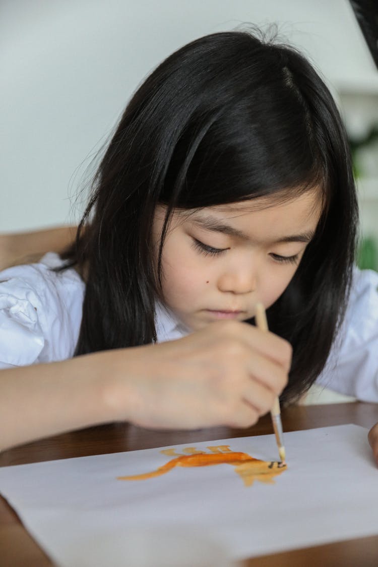 Serious Asian Kid Painting With Aquarelle In Art Studio