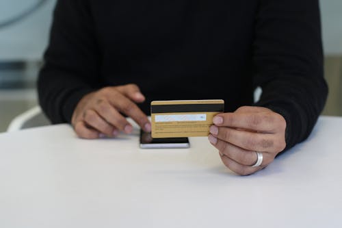 Free Close-Up Shot of a Person Holding a Bank Card Stock Photo