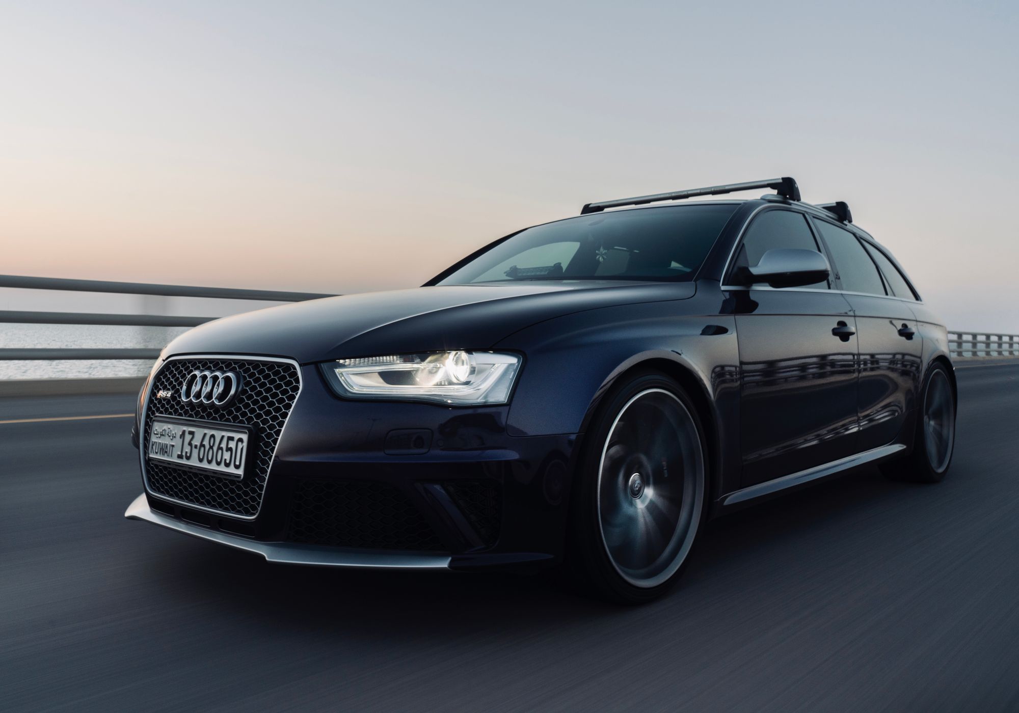 Premium sedan driving along a Dubai highway at sunset