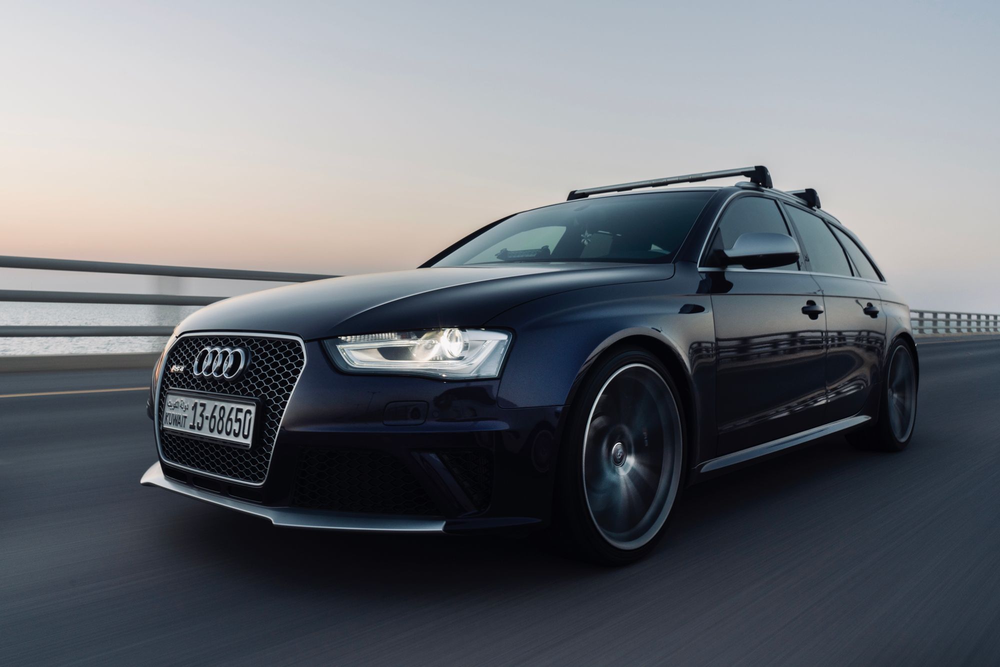 Black luxury vehicle travelling on the road