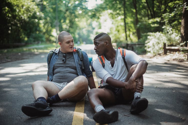 Gay Couple Resting On Road