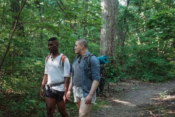 Two hikers on a forest trail, photo by Kamaji Ogino on Pexels