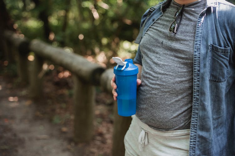 Crop Man With Plastic Bottle Of Water