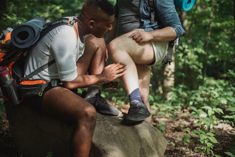 Multiethnic Friends Searching For Ticks While Hiking