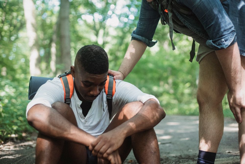 Black friends supporting each other outdoors
