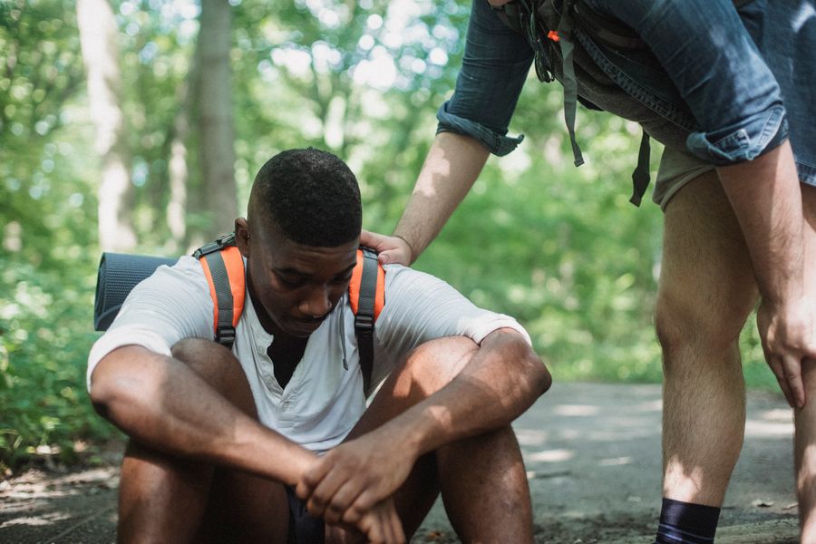 Black friends supporting each other outdoors