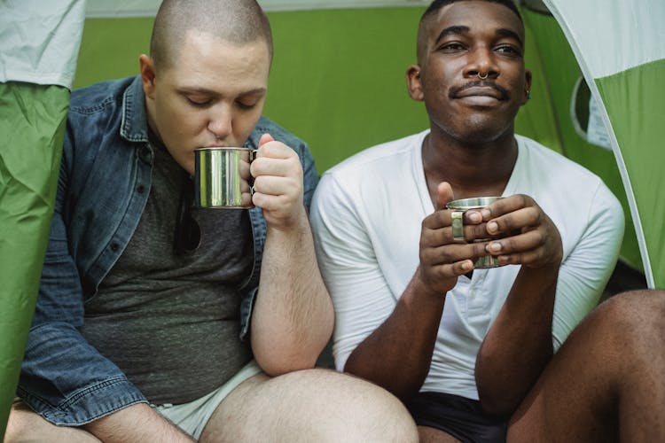 Male Diverse Friends Drinking Tea In Tent