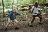 Active diverse same sex having hike in forest