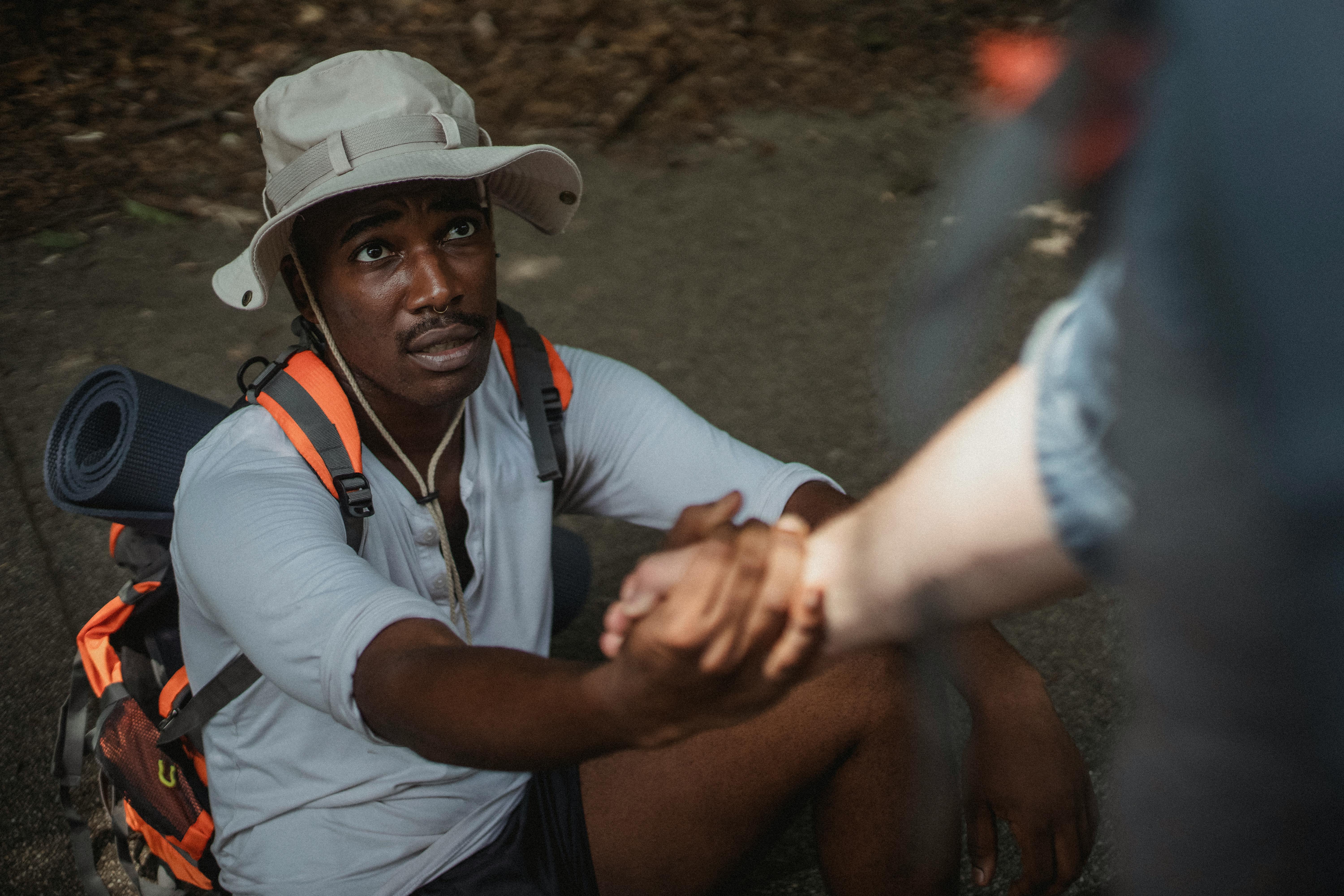 black male hiker holding hand of anonymous homosexual partner