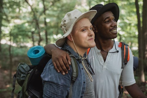 Multiracial men hugging in nature