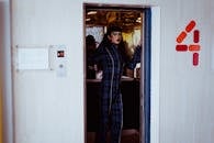 Stylish woman standing in elevator