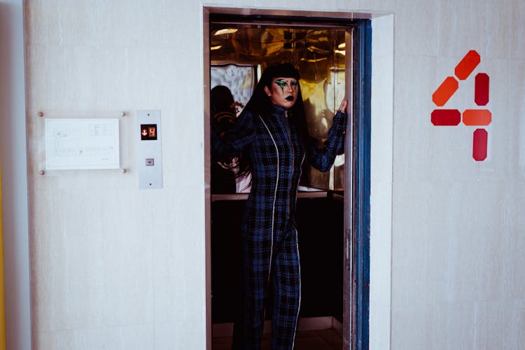 Stylish Woman Standing In Elevator