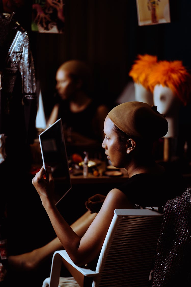 Asian Woman With Bright Makeup Looking At Mirror