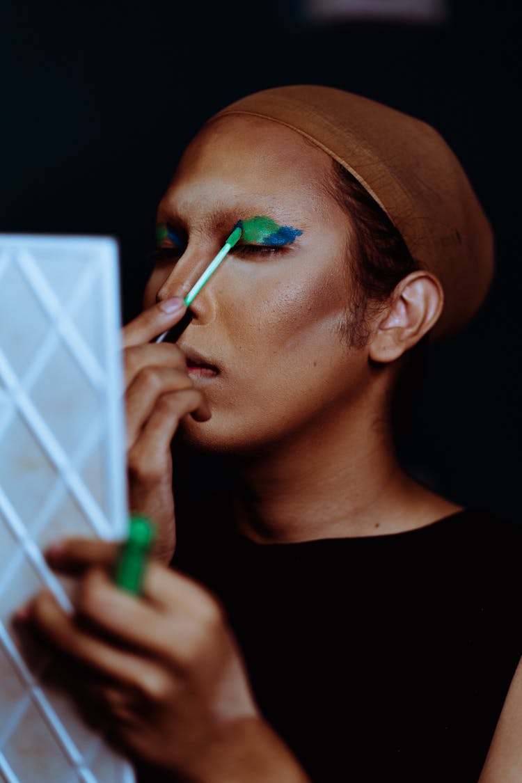 Ethnic Woman Applying Makeup On Eyelid Using Applicator