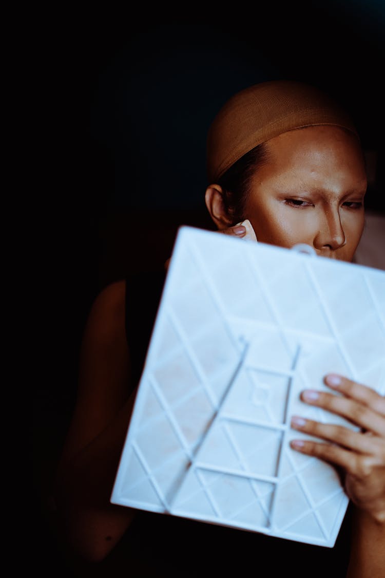 Asian Woman Spreading Rouge And Highlighter On Face