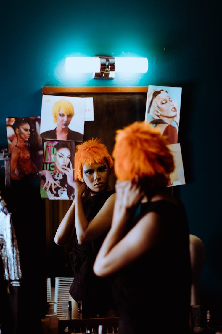 Serious Woman With Makeup Putting On Wig