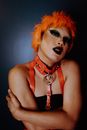 Sensual young ethnic transsexual man embracing self and looking at camera