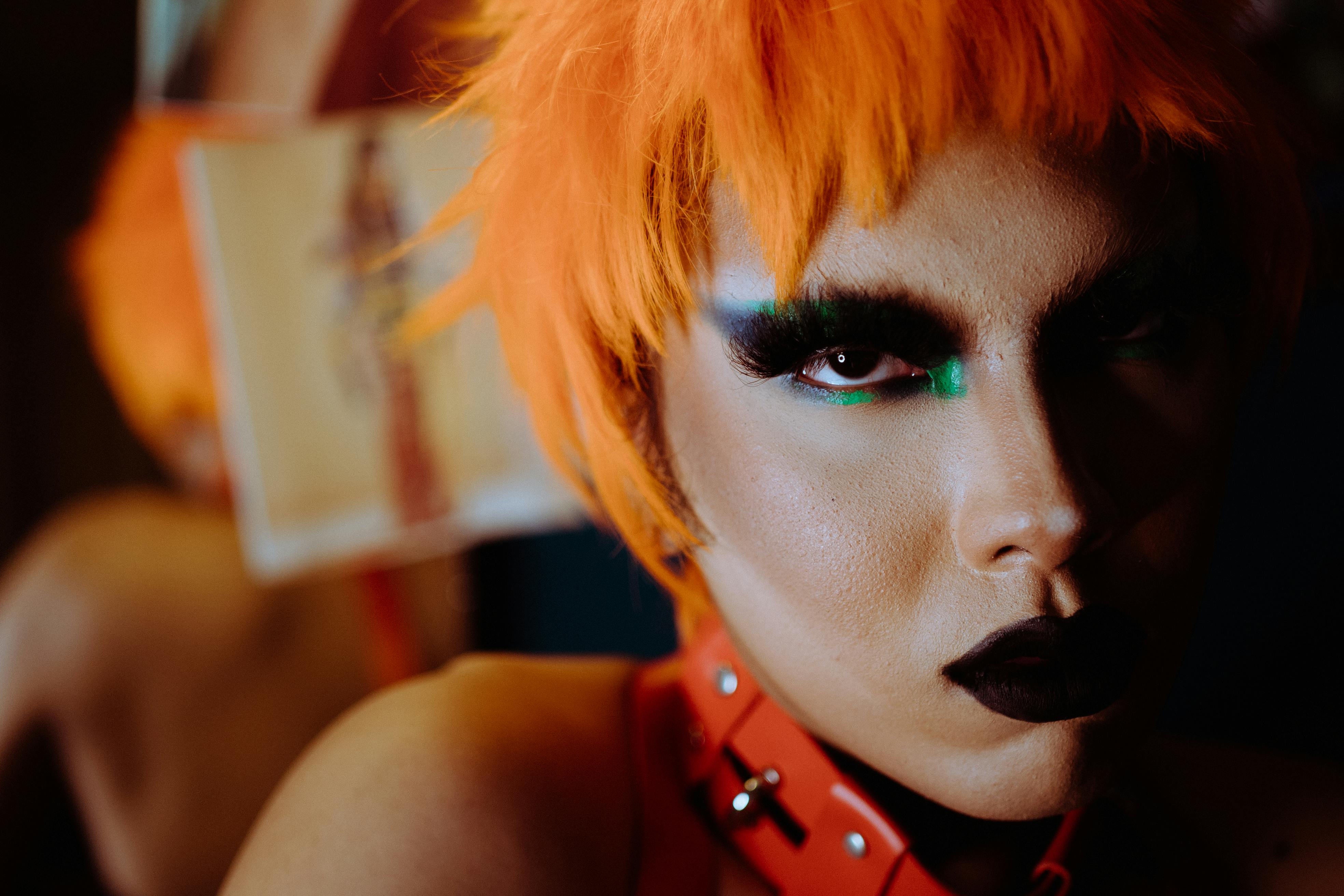 crop extravagant woman with bright makeup and dyed hair