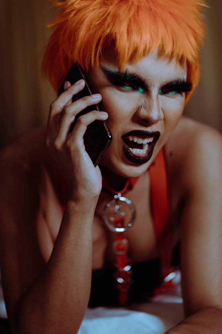 Angry Young Androgynous Person Shouting While Talking On Smartphone